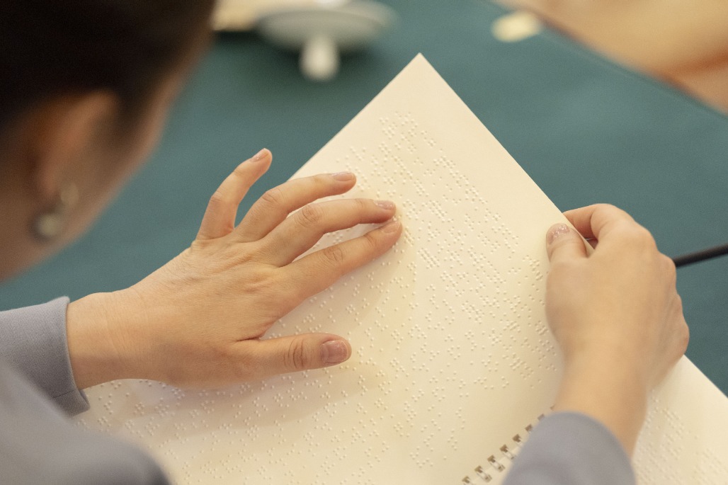 In Pics: Govt work report in Braille shows China's care, support for people with disabilities